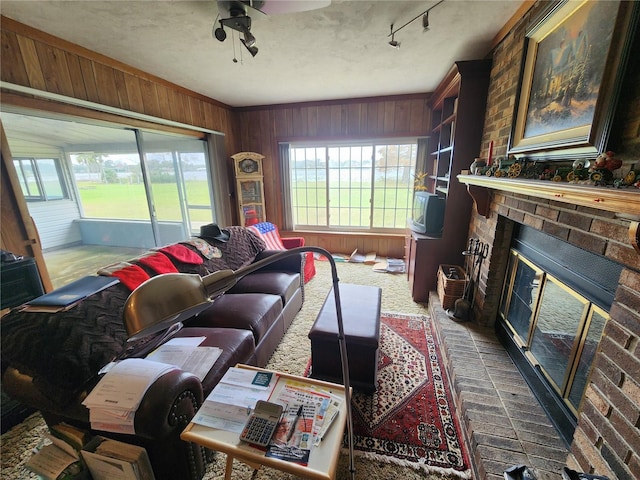 living room featuring ceiling fan and a brick fireplace