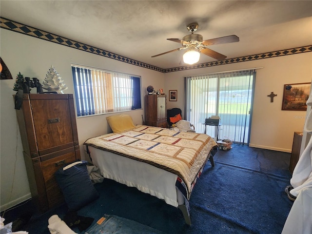 bedroom with dark colored carpet, ceiling fan, access to exterior, and multiple windows