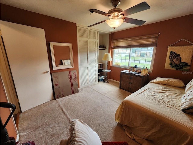 carpeted bedroom with ceiling fan and a closet