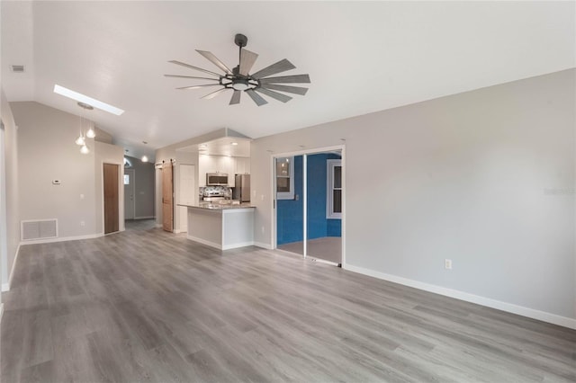 unfurnished living room with ceiling fan, wood-type flooring, and lofted ceiling