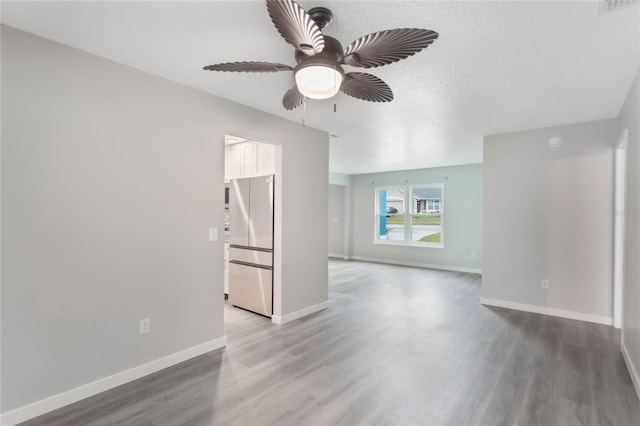 unfurnished living room with a textured ceiling, hardwood / wood-style flooring, and ceiling fan