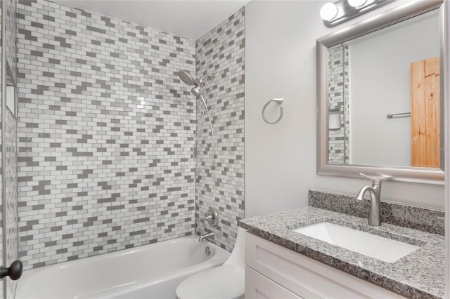 full bathroom with vanity, toilet, and tiled shower / bath combo