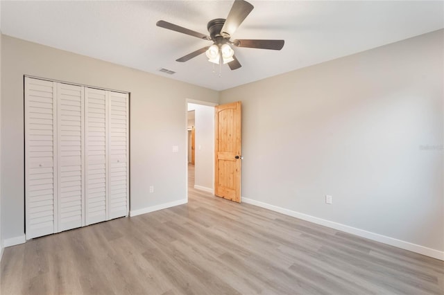 unfurnished bedroom featuring ceiling fan, light hardwood / wood-style flooring, and a closet