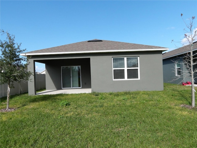 rear view of property with a patio area and a yard