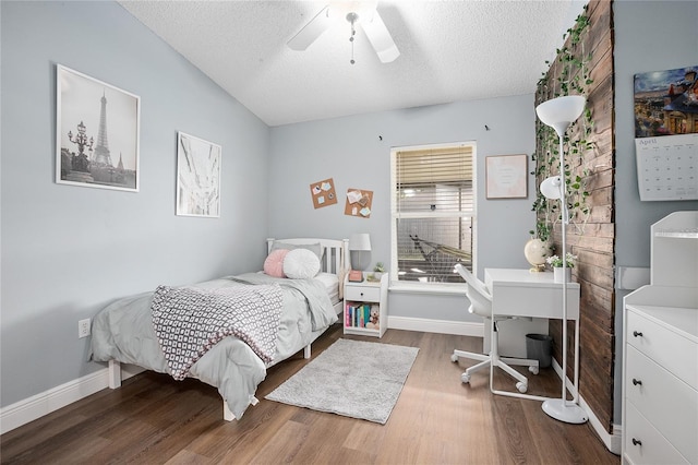 bedroom with hardwood / wood-style floors, a textured ceiling, and ceiling fan