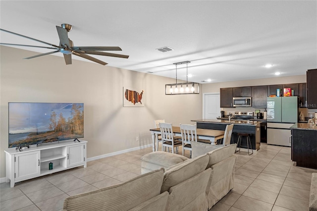 living room with ceiling fan and light tile patterned floors