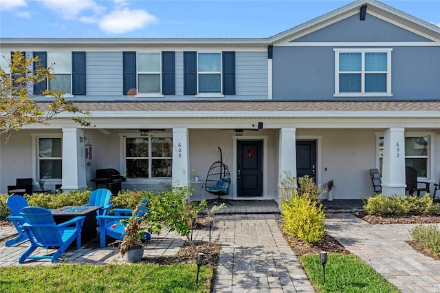 view of front of home with ceiling fan and a porch