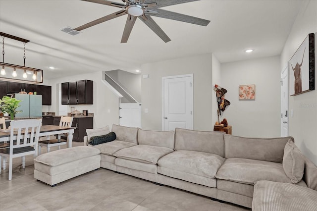 living area featuring ceiling fan, visible vents, and recessed lighting