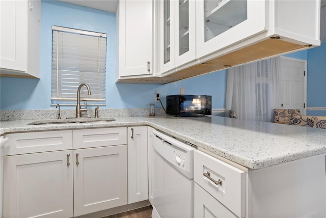 kitchen featuring sink, white cabinetry, and white dishwasher