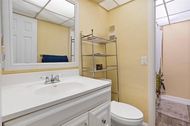 bathroom featuring hardwood / wood-style flooring, toilet, and vanity