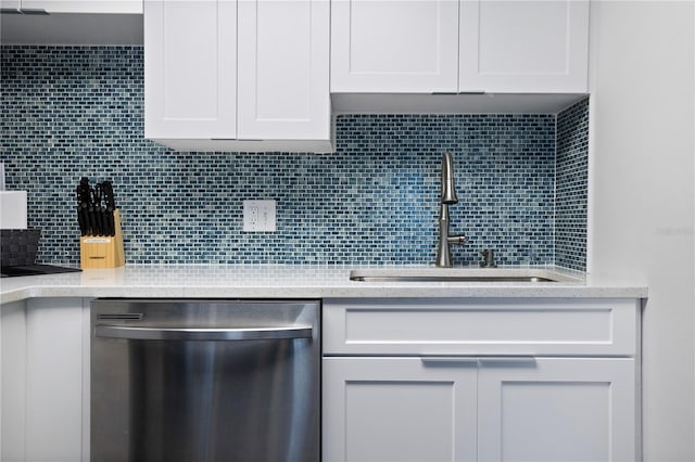 kitchen with dishwasher, white cabinets, sink, decorative backsplash, and light stone counters