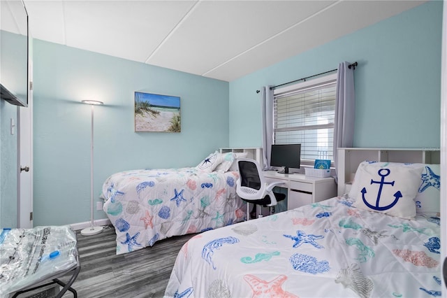 bedroom with dark wood-type flooring