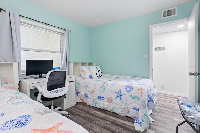 bedroom with hardwood / wood-style floors