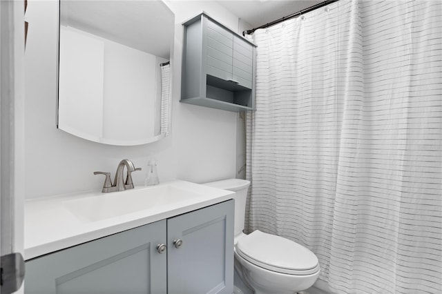 bathroom with vanity, a shower with shower curtain, and toilet