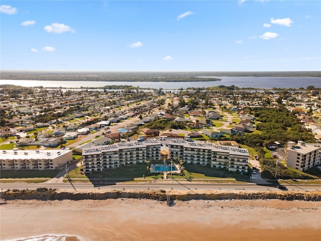 bird's eye view with a water view and a beach view