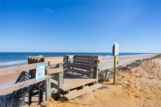 view of property's community featuring a beach view and a water view