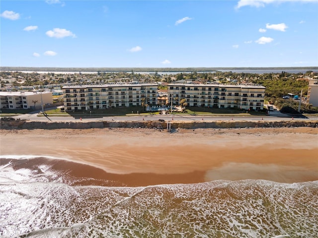 drone / aerial view with a water view and a beach view