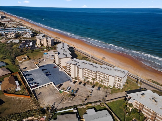 birds eye view of property featuring a view of the beach and a water view