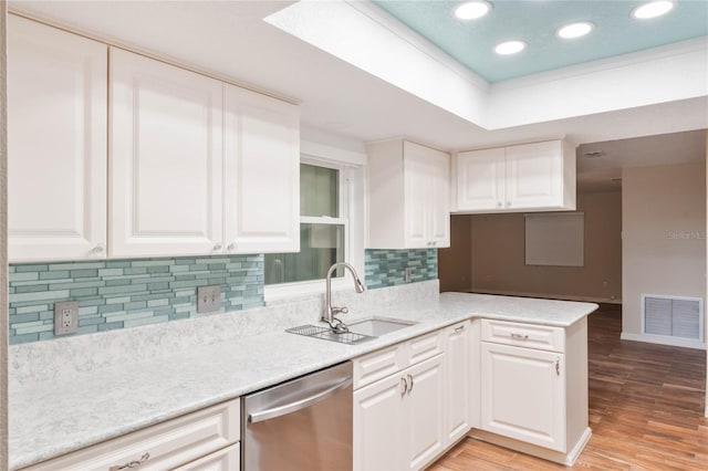 kitchen with white cabinets, dishwasher, kitchen peninsula, and sink