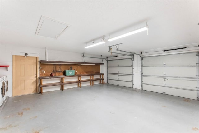 garage featuring water heater and independent washer and dryer