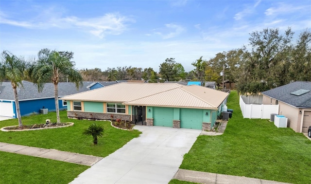 ranch-style house with an attached garage, fence, stone siding, driveway, and a front lawn