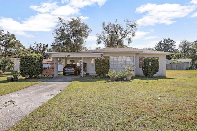 ranch-style home featuring a carport and a front yard