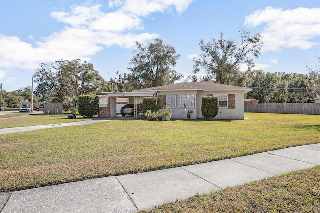 ranch-style home with a carport and a front lawn