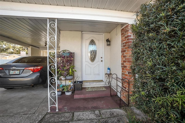 doorway to property featuring a carport