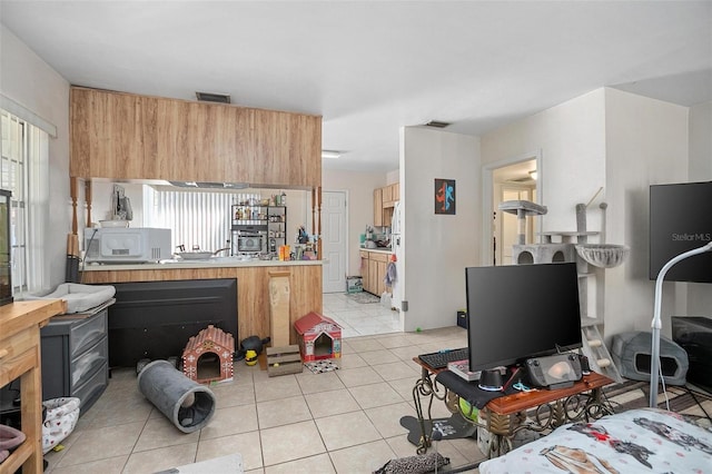 kitchen featuring kitchen peninsula and light tile patterned floors