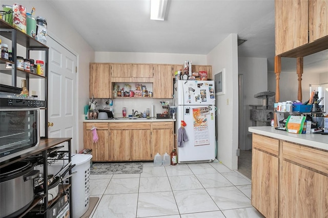 kitchen with white refrigerator and sink