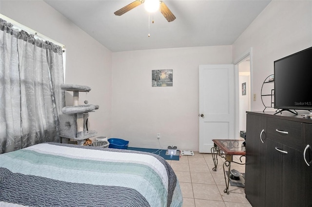 bedroom with ceiling fan and light tile patterned flooring