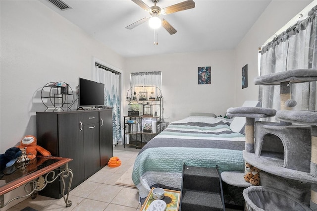 bedroom featuring light tile patterned floors and ceiling fan