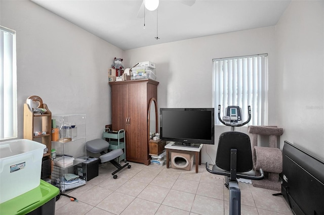 tiled office space featuring ceiling fan