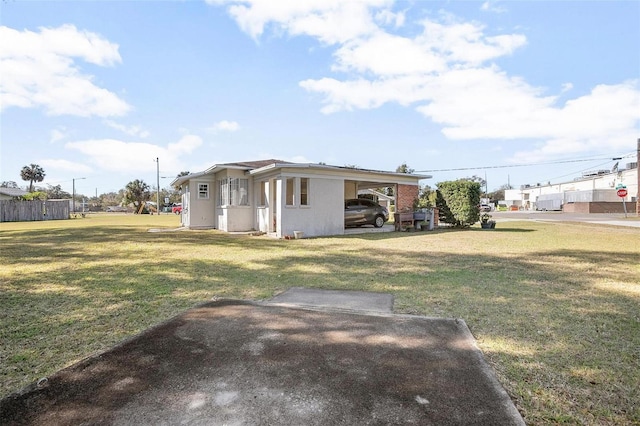 view of home's exterior featuring a yard and a carport