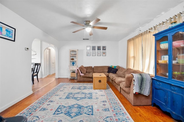 living room with hardwood / wood-style floors and ceiling fan