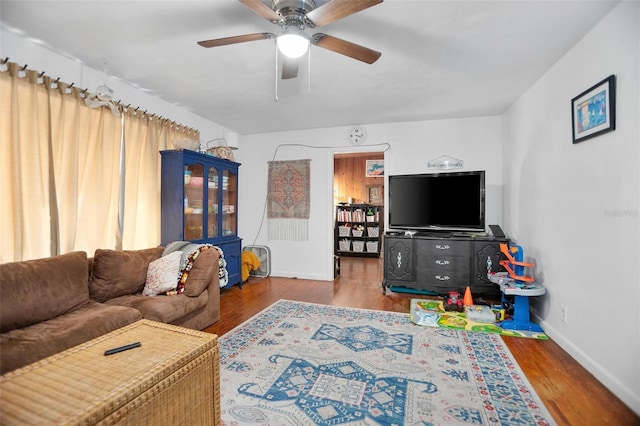 living room featuring wood-type flooring and ceiling fan