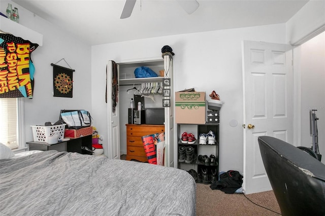 carpeted bedroom featuring ceiling fan and a closet