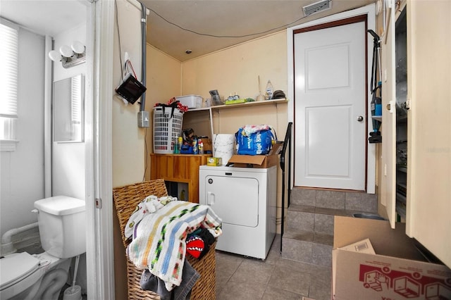 laundry area featuring tile patterned flooring and washer / dryer