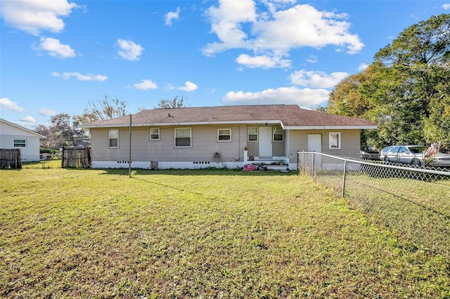 rear view of house with a yard