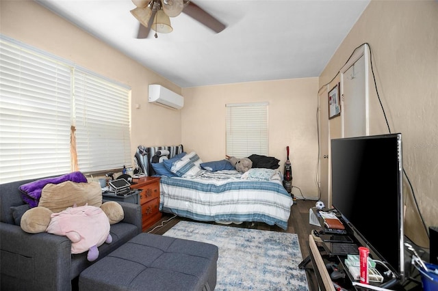 bedroom with dark hardwood / wood-style floors, a wall mounted AC, and ceiling fan