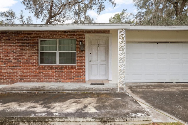 view of exterior entry featuring a garage