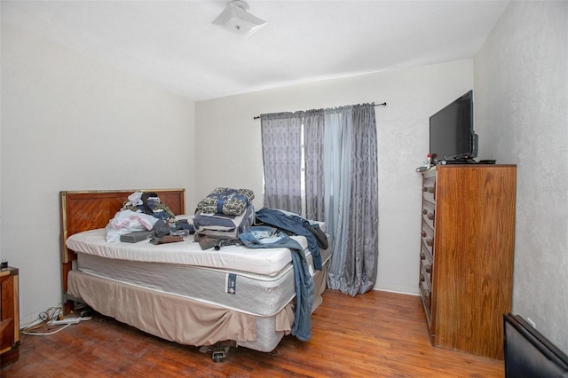 bedroom with hardwood / wood-style floors