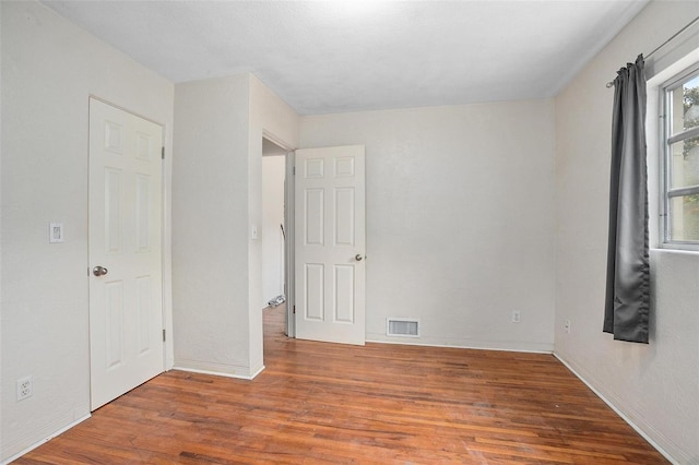 unfurnished room featuring hardwood / wood-style flooring