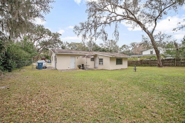 back of property featuring a yard