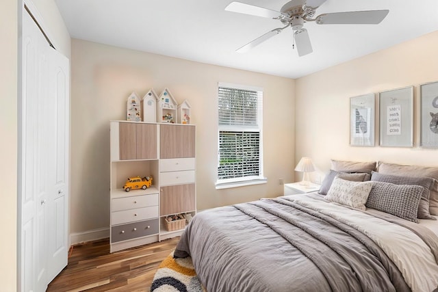 bedroom with wood-type flooring, a closet, and ceiling fan