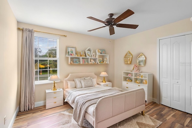 bedroom featuring ceiling fan, a closet, and hardwood / wood-style floors