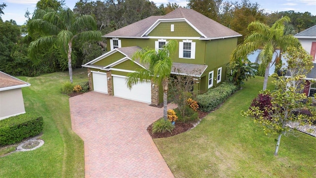 view of front of house featuring a front lawn and a garage