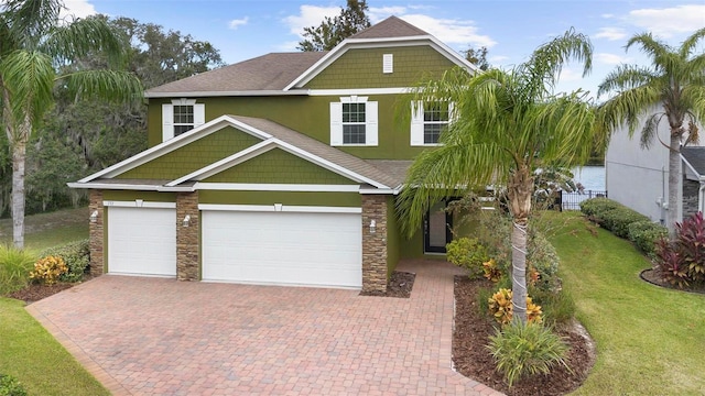 craftsman-style house with a garage and a front lawn