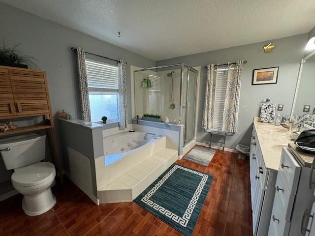 full bathroom featuring vanity, shower with separate bathtub, a textured ceiling, and toilet