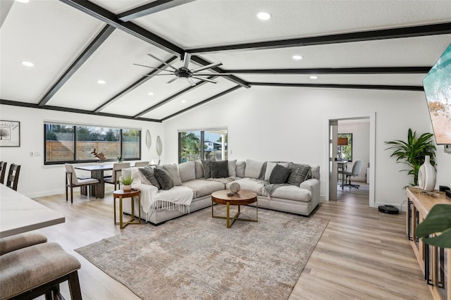 living room featuring light wood-type flooring, lofted ceiling with beams, and ceiling fan